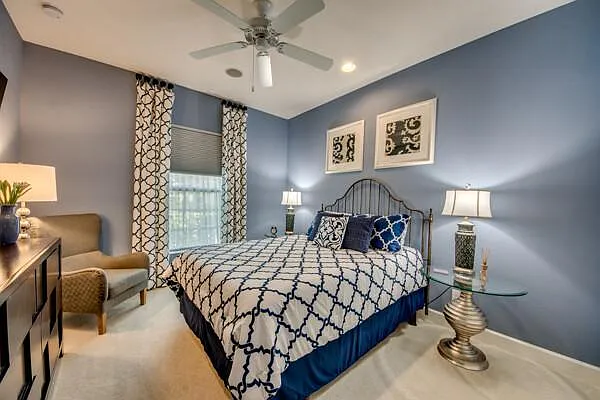 Second guest bedroom with queen bed, blue walls, metal headboard, blue/white bedding