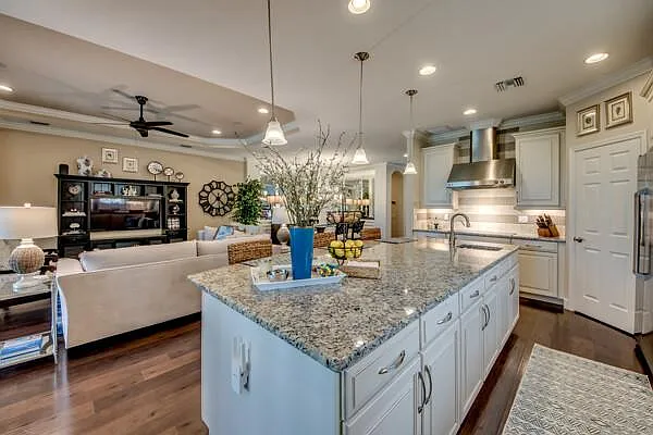 Kitchen island in foreground with open living room behind — shows the full great room